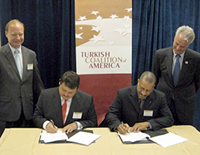 Congressman Michael McMahon (D-NY-13th) and Lincoln McCurdy witness MOU signing by Dr. Burak Kuntay of Bahcesehir and Mr. Michael Hester of UNCFSP.